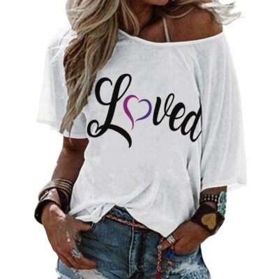 This women’s “Loved” t-shirt from Heart’s Desire Intl combines comfort and style with a meaningful message. Crafted from soft, breathable fabric, it features the word “Loved” in a simple yet bold desi